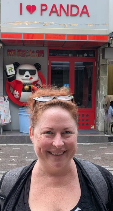 Anna in front of an I Love Panda sign.