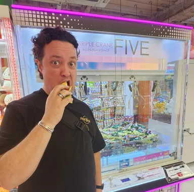 Levi eating claw machine snacks.