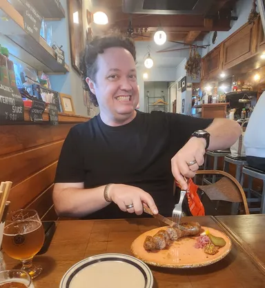 Levi eating sausages at Barchies in Kamakura