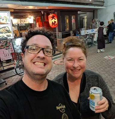 Levi & Anna with drinks outside Showboat