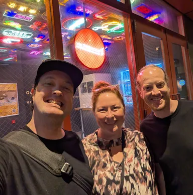 Group picture outside neon smoking room