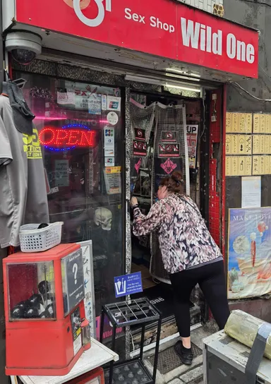 Anna entering a sex shop.