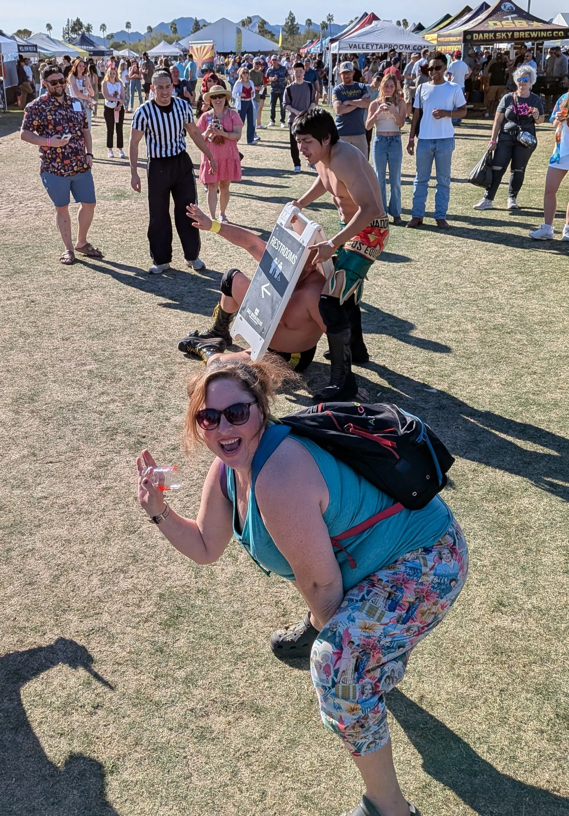 Anna posing in front of wrestlers